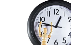 Mannequin reaching for the hands of time. Metaphor/concept for time management.